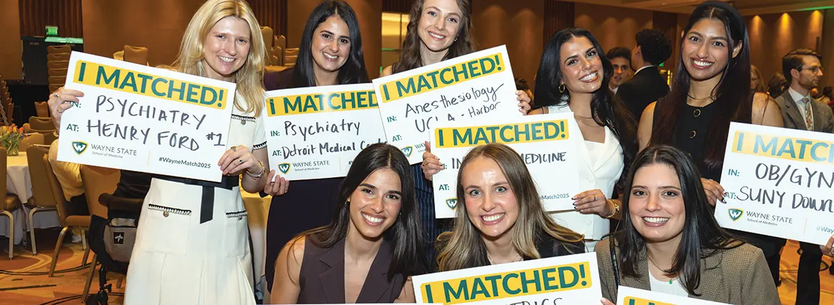 students with signs that say I MATCHED!