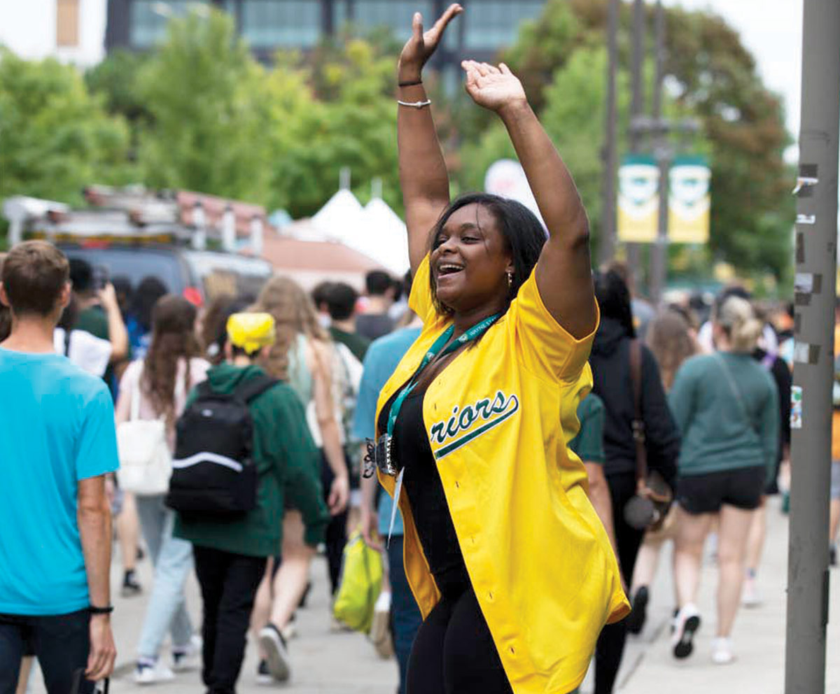 woman in a yellow "Warriors" jersey