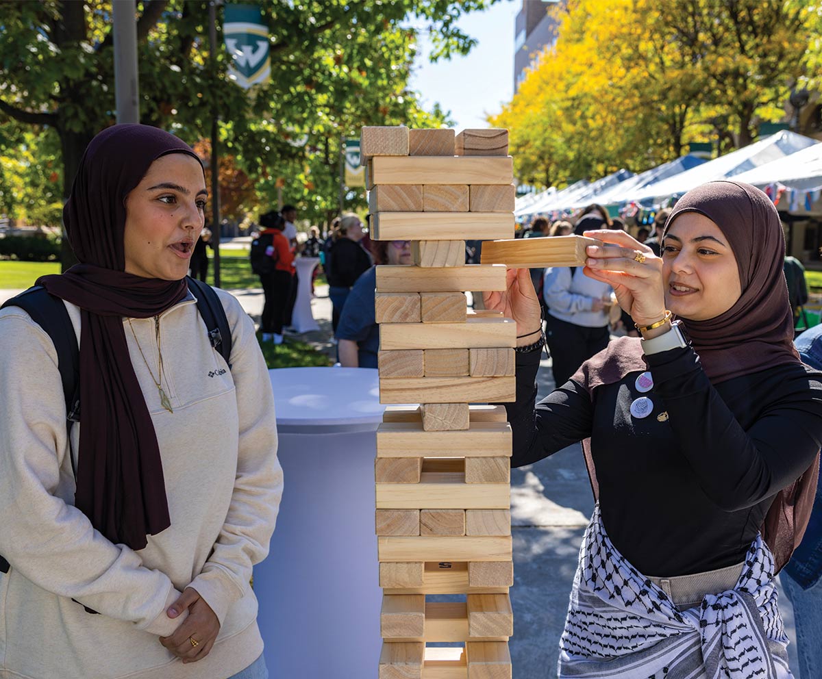 Two women playing oversized game of Jenga