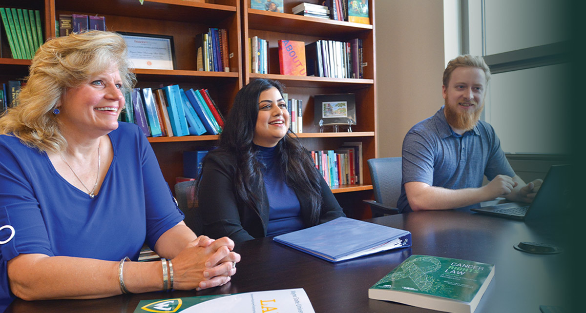 Three people at a conference table