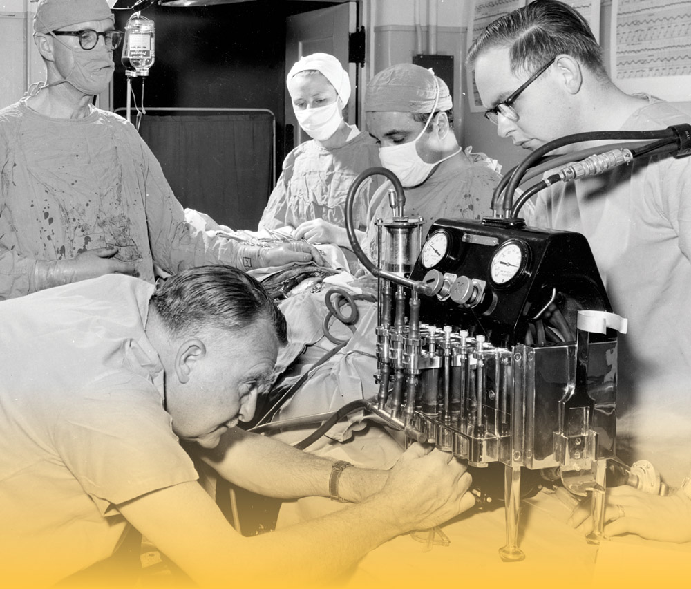 four surgeons working on a patient