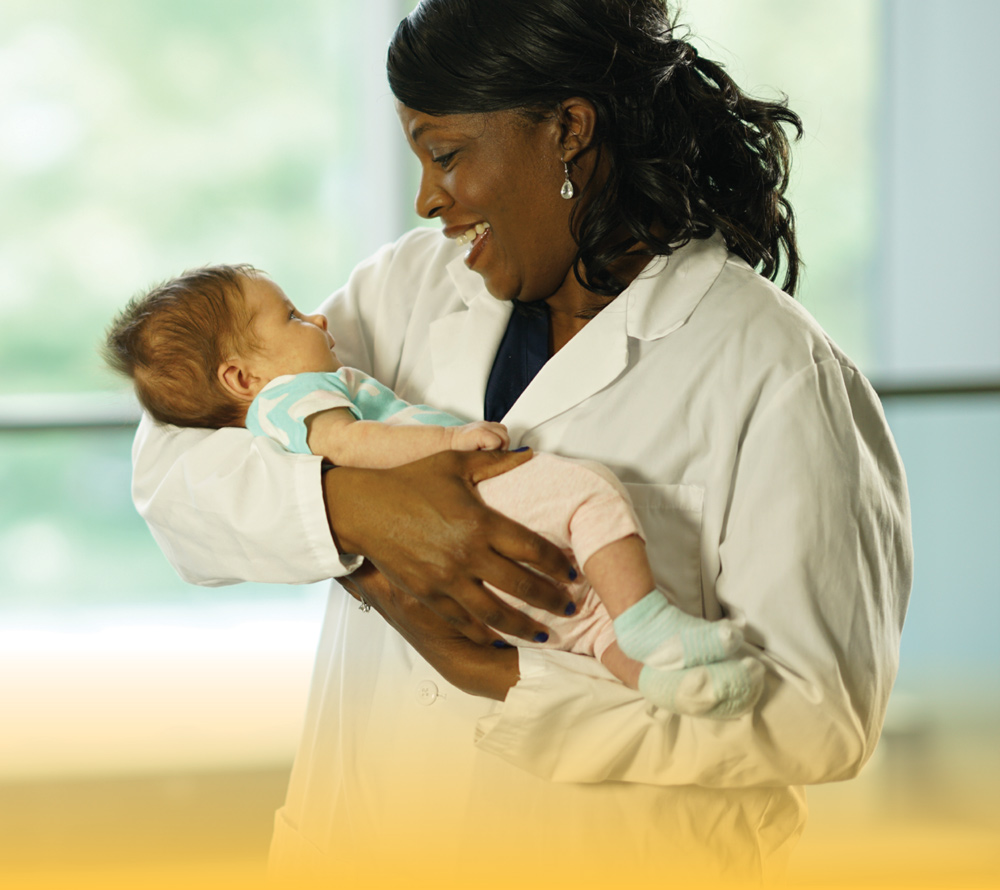 healthcare professional holding baby