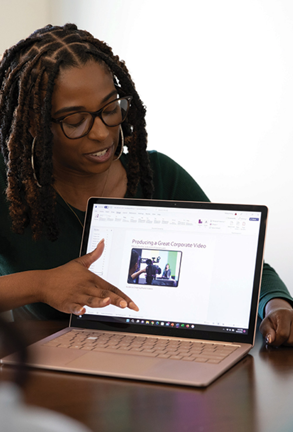 woman pointing to a laptop